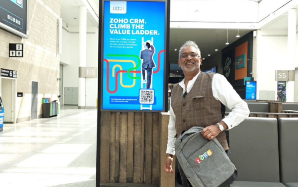 Vivek Gargav, a CRM consultant, next to a Zoho CRM advert